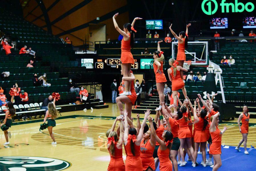 Colorado State University Cheerleaders performing at halftime in the Moby Arena during the orange out game.