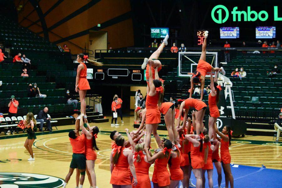 Colorado State University Cheerleaders performing at halftime in the Moby Arena during the orange out game.
