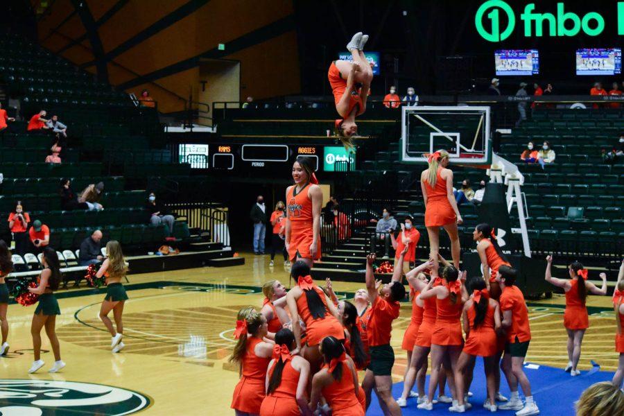 Colorado State University Cheerleaders performing at halftime in the Moby Arena during the orange out game.