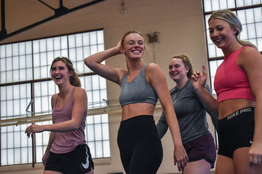 Senior cheerleader, Kaiya Jenkins walking off the mat during practice in happiness after successfully hitting a stunt in the Glen Morris Field House on Feb. 14, 2022.