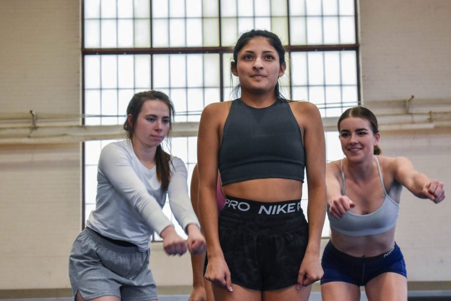 Colorado State University cheerleaders preparing for a stunt during one of the final practices for seniors as they prepare to graduate in the spring.