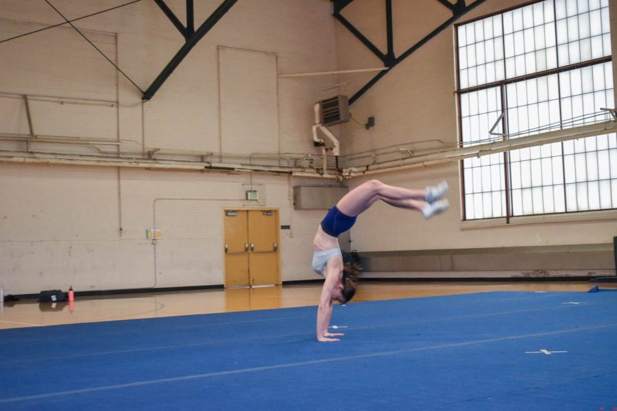 Savannah Woods, senior cheerleader at Colorado State University caught in mid air as she finishes a back-hand-spring.