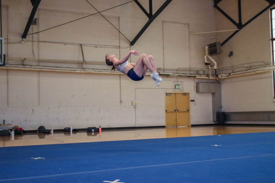 Savannah Woods, senior cheerleader at Colorado State University caught in mid air as she finishes a back tuck.
