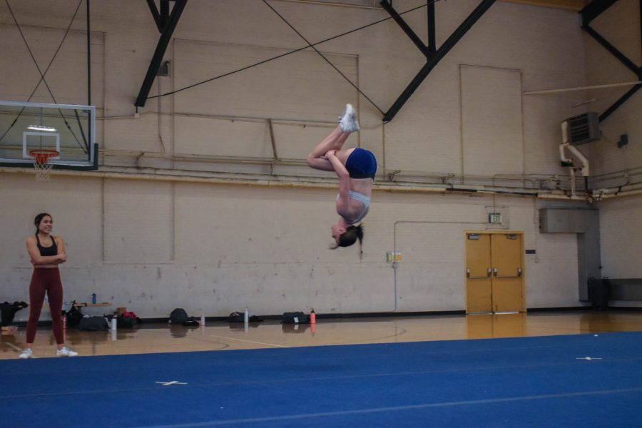 Savannah Woods, senior cheerleader at Colorado State University caught in mid air as she finishes a back tuck.