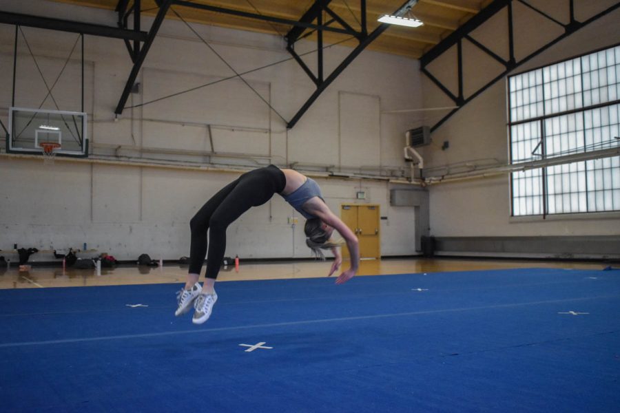 Kaiya Jenkins, senior cheerleader at Colorado State University caught in mid air as she finishes a back-hand-spring.