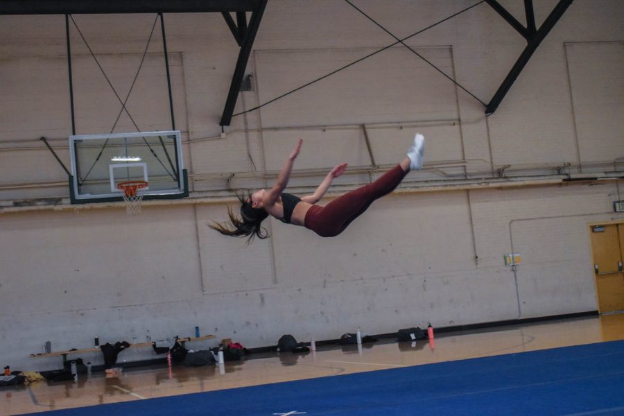 Bianca Gonzalez, senior cheerleader at Colorado State University caught in mid air as she finishes a layout.