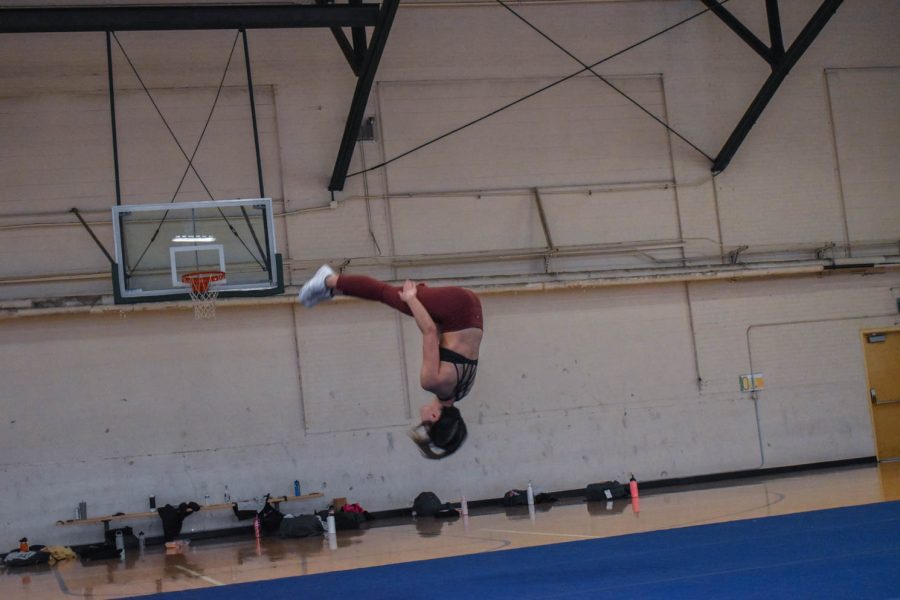 Bianca Gonzalez, senior cheerleader at Colorado State University caught in mid air as she finishes a layout.