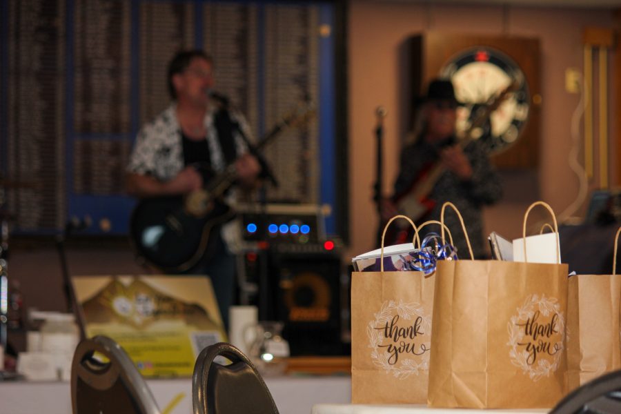 Goodie bags fill a table while the band, Soda Blue plays.
