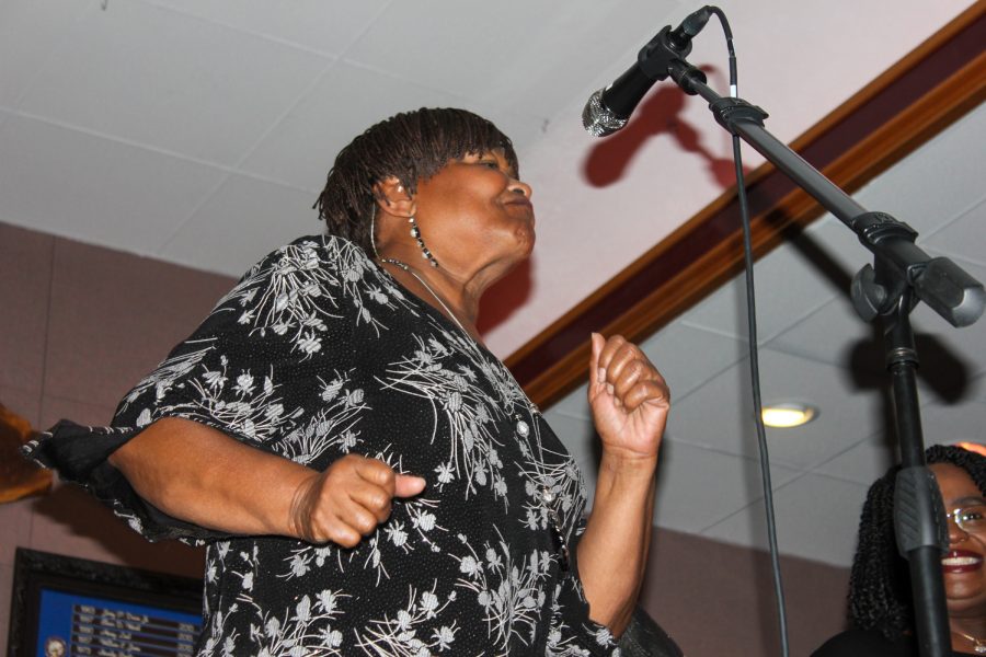 Hazel Miller dances on stage as she performs for fire victims.