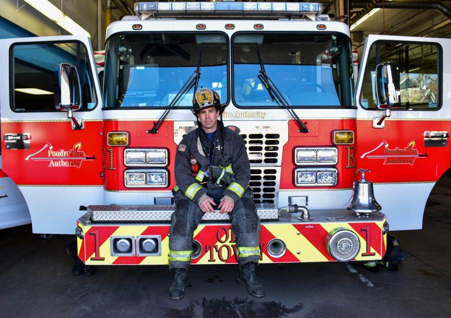 Chris Dini, Captain of the Poudre Fire Authority Station 1 poses for a portrait while sitting on top of a fire truck on Feb. 28, 2021 in Fort Collins, Colo.