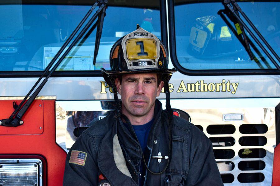 Chris Dini, Captain of the Poudre Fire Authority Station 1 poses for a portrait while sitting on top of a fire truck on Feb. 28, 2021 in Fort Collins, Colo.