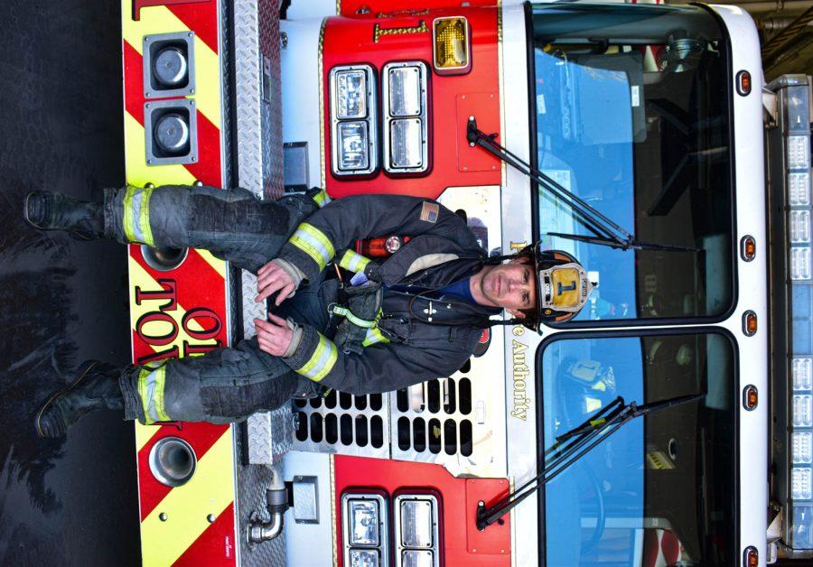 Chris Dini, Captain of the Poudre Fire Authority Station 1 poses for a portrait while sitting on top of a fire truck on Feb. 28, 2021 in Fort Collins, Colo.