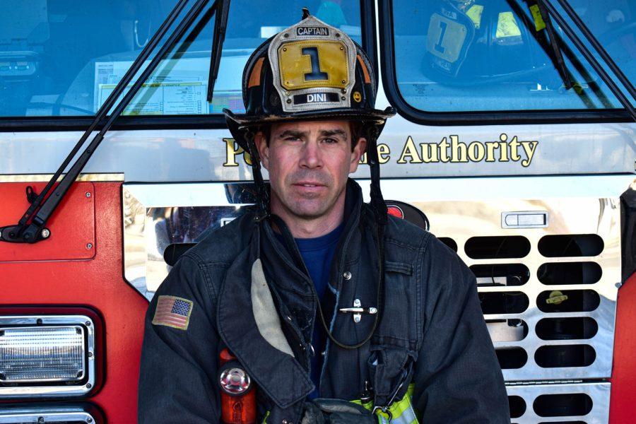 Chris Dini, Captain of the Poudre Fire Authority Station 1 poses for a portrait while sitting on top of a fire truck on Feb. 28, 2021 in Fort Collins, Colo.