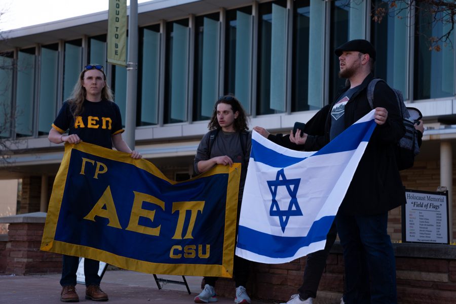 Matthew Davis, Miles Saitz, Justin Deustch and Jacob Margo-Ginsberg, Brother-At-Large, of Colorado State University’s, Alpha Epsilon Pi, Jewish fraternity sing in remembrance of The Holocaust. “There are over 2,000 flags in the field of flags (each flag representing 5,000 deaths from The Holocaust),” Margo-Ginsberg stated, “there are 35,000 undergraduate students here on CSU, that is equivalent to seven flags. Just seven.”