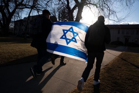 Justin Deutsch and Jacob Margo-Ginsberg, Brother-At-Large, of Colorado State University’s, Alpha Epsilon Pi, Jewish fraternity walk through The Oval for The Holocaust Walk to Remember wielding an Israeli flag Mar 4. Margo-Ginsberg commented, “We walk to remember but we never forget.”