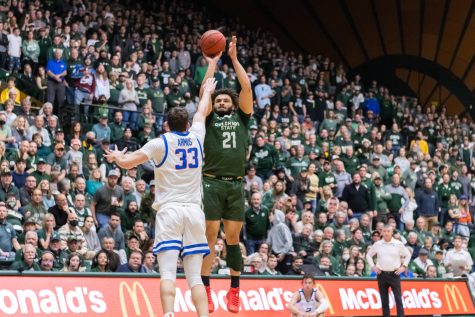 Colorado State Forward David Roddy (21) shoots over a defender from the three point line.