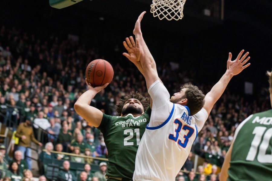 Colorado State Forward David Roddy (21) drives against a defender and makes a contested layup.