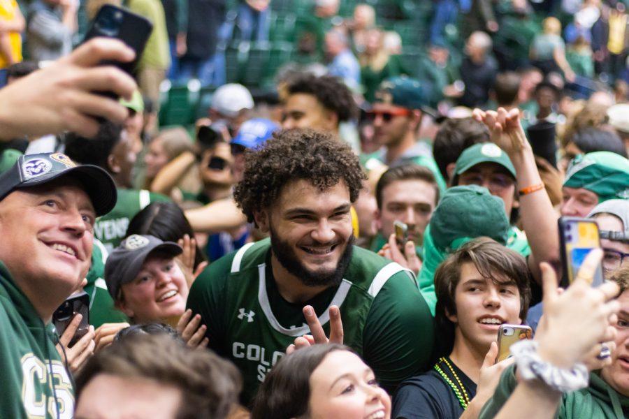 Colorado State Forward David Roddy (21) smiles for a photo while surrounded by fans after CSUs stunning win against Boise State University.