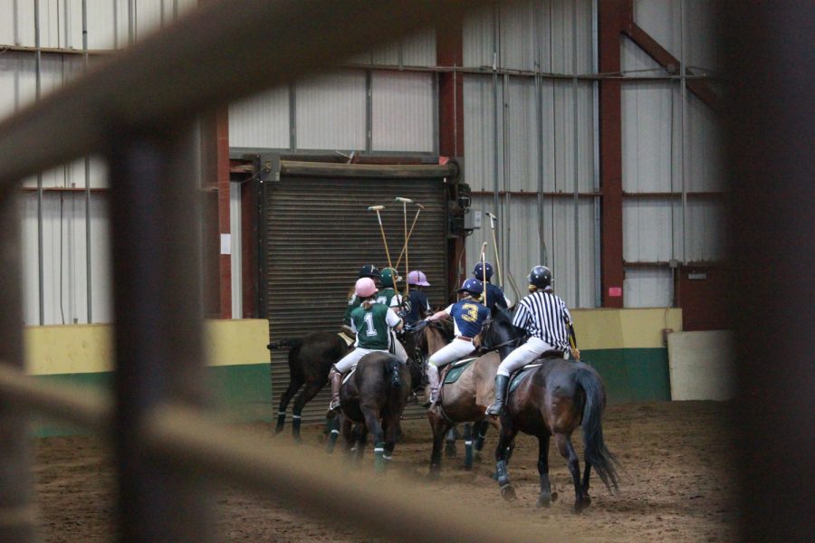 A mounted referee watches the players and moves that are made.