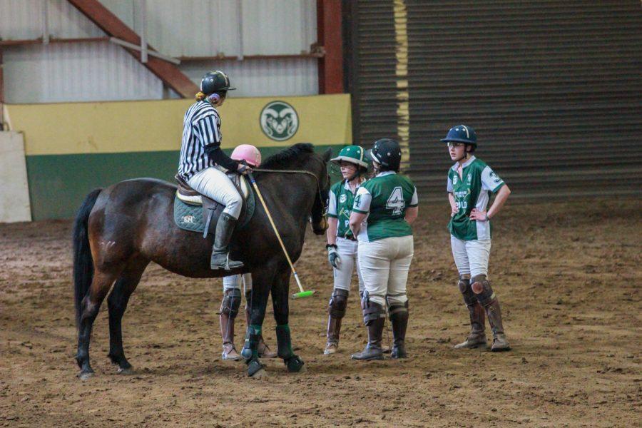 CSU riders talk with the referee during half time.