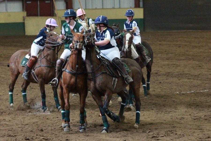 A CSU rider and a Montana State rider attempt to push each other out of the way, to allow their teammates to try and get the ball.