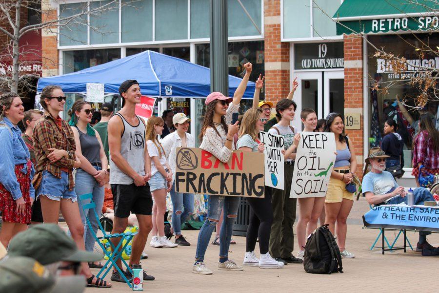 Participants react to a speaker during the climate strike in Old Town Fort Collins.