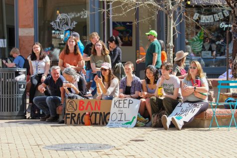 Participants sit and listen to speakers at the climate strike in Old Town Fort Collins.