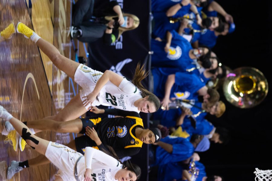 Cali Clark (22) and Clara Gomez (12) fighting for the ball while they play the San Jose Spartans during the first game of Mountain West Tournament.