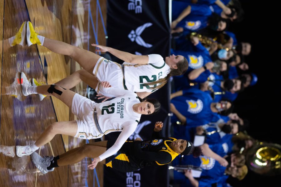 Cali Clark (22) and Clara Gomez (12) fighting for the ball while they play the San Jose Spartans during the first game of Mountain West Tournament.