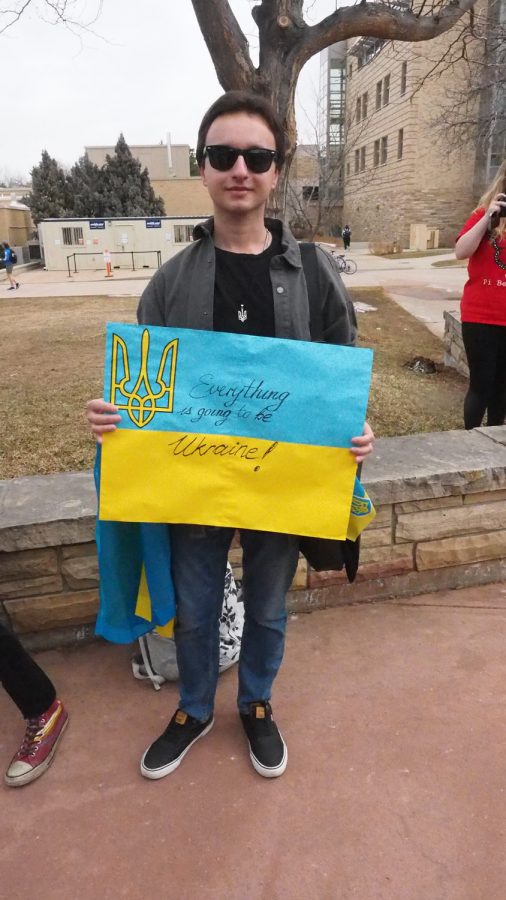Colorado State graduate student Tymofiy Lutsiv stands holding a poster of the Ukranian flag with the words "everything is going to be Ukraine!" written on it on the Lory Student Center Plaza March 3, 2022.