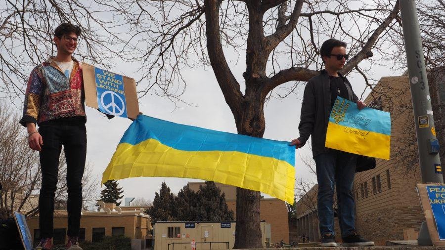 Colorado state Graduate students Benja Kromash and Tymofiy Lutsiv hold the Ukrainian flag outside the Lory Student Center March 3, 2022