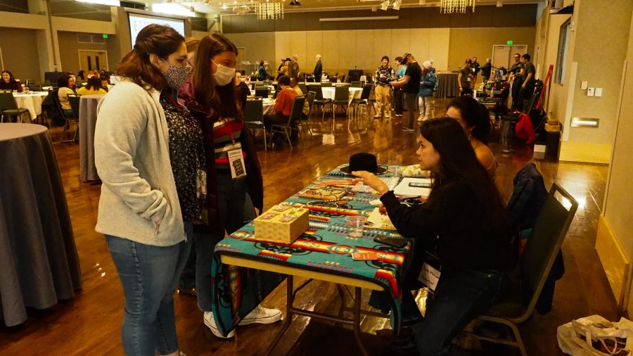 Colorado State Environmental Engineering major Claire McWilliams sells her bead jewelery in the Lory Student Center Grand Ballroom to CSU students Isabella Ortega and Jenna Gibbons March 5, 2022