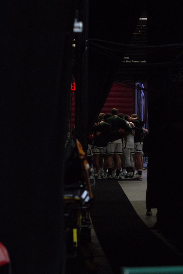 The Colorado State Mens Basketball Team huddles up before entering the court.