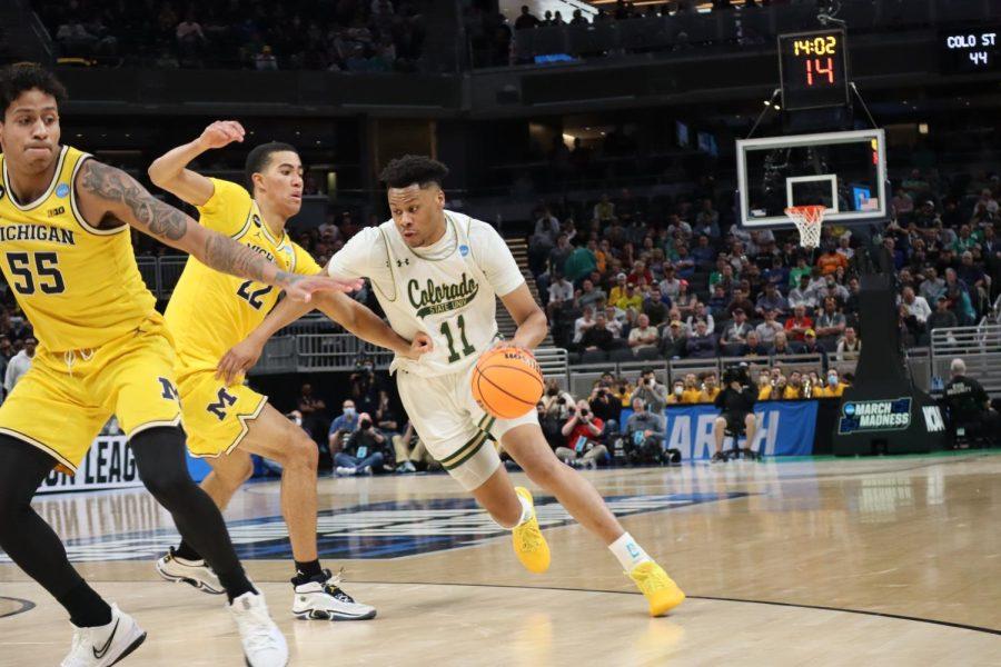 Dischon+Thomas+%2811%29+dribbles+into+the+paint+as+University+of+Michigan+players+Caleb+Houstan+%2822%29+and+Eli+Brooks+%2855%29+guard+him+March+17%2C+2022%2C+at+Gainbridge+Fieldhouse+in+Indianapolis%2C+Indiana.+Michigan+beat+Colorado+State+University+75-63+in+the+first+round+of+the+NCAA+Tournament.