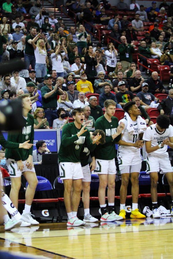 The CSU Mens Basketball team cheers on their players.