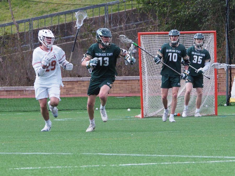 Colorado State defender Will Farkas (13) runs the ball upfield as University of Texas attack William Blair (29) pursues.