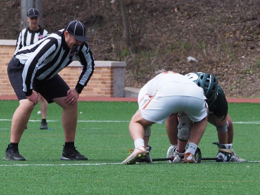 Colorado Sate Face off Specialist Christopher Reed (25) faces off with University of Texas FOS Christian Deangelis (16) March 13, 2022.