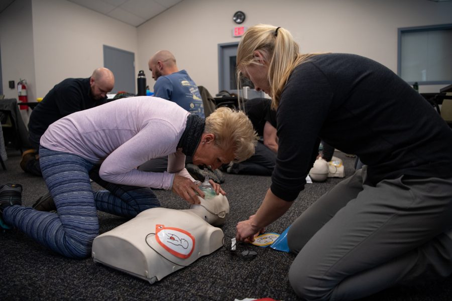 6. Diane Abshire and Brittany Decker practice applying an Automated External Defibrillator, doing chest compressions and using a face mask in a CPR class March 5.