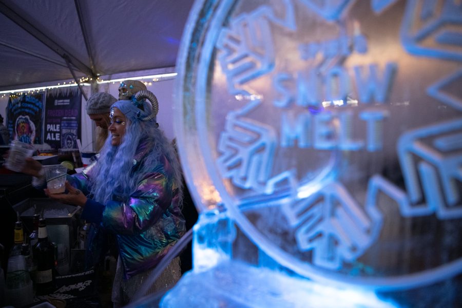 Nichole Drew serves drinks at the annual Frozen Dead Guy Days festival March 18.