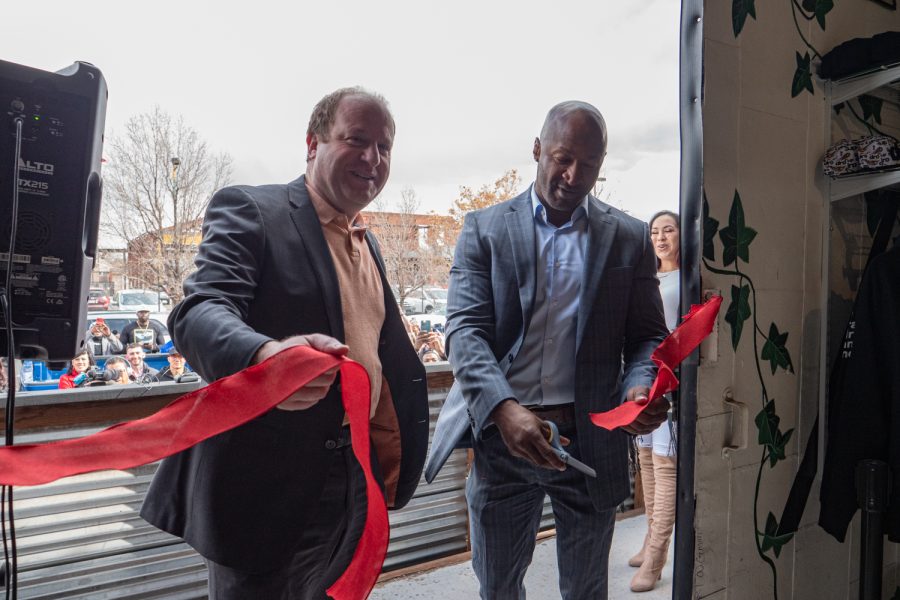 Gov. Polis and Dewayne Benjamin in the midst ribbon cutting