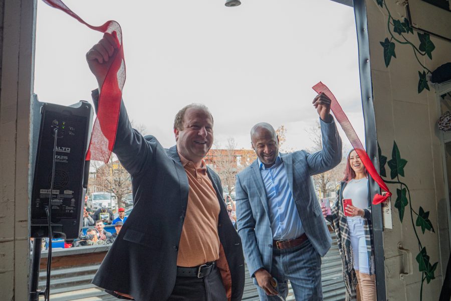 Gov. Polis and Dewayne Benjamin in the midst ribbon cutting