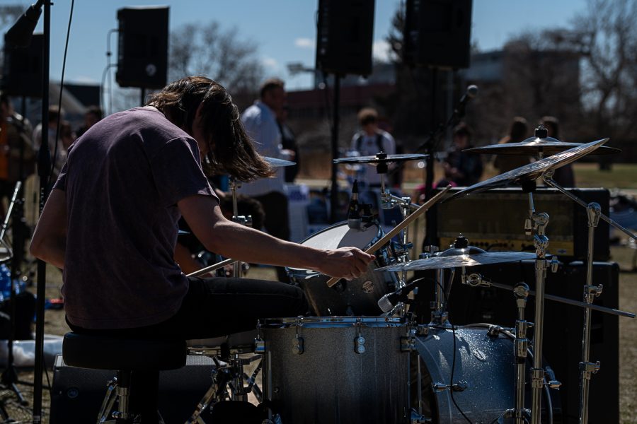 Thomas Culp, of the band Hygeia, Plays drums to an original song during K-Colorado State University’s FoolsFest Apr 1. “It was so fun I think the coolest thing was seeing people vibe our music that we wrote.” Culp stated.