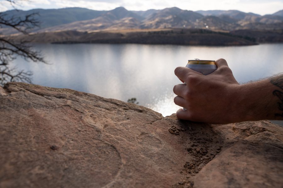 Photo Illustration of Dylan Medina, a Colorado State University chemistry major, holding a beer at the Horsetooth Reservoir Apr 2.