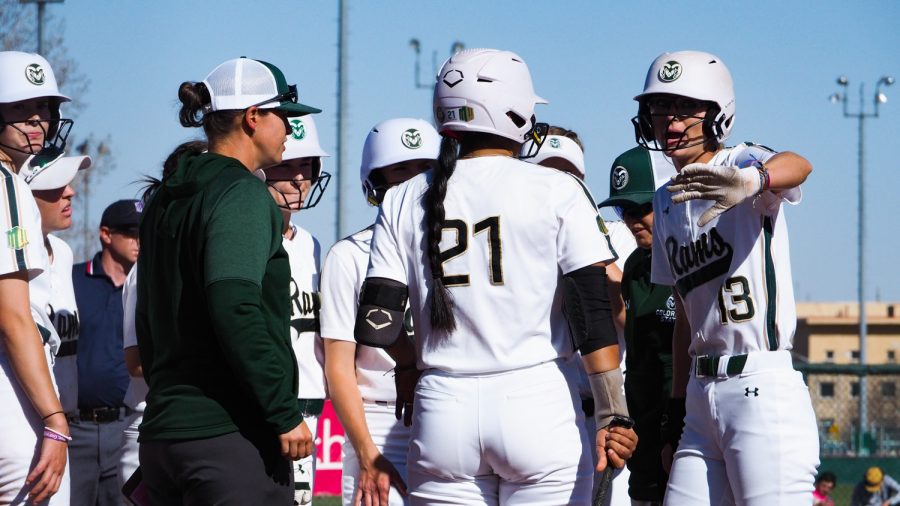 Colorado State first base Hailey Smith (13) goes over a game plan with Danielle Serna (21) April 8, 2022.