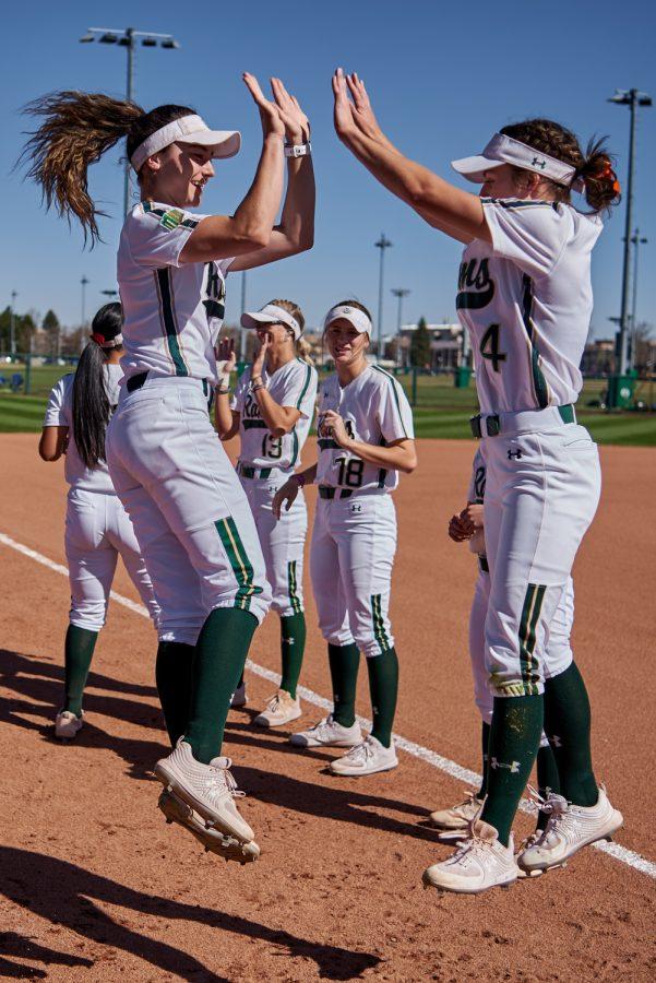 Colorado State outfield Ashley Michelena (4) welcomes her team members to the field before the Colorado State softball game April 8, 2022.