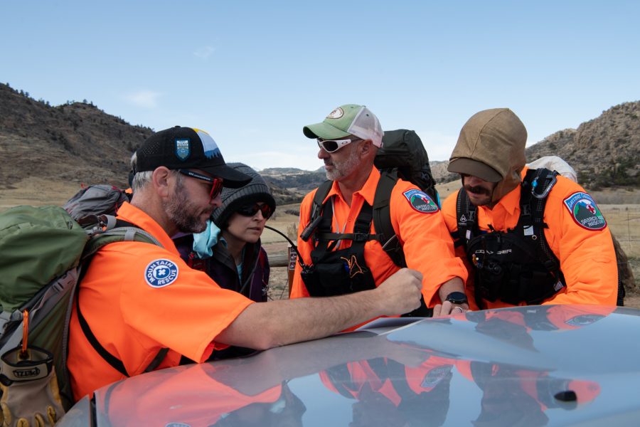 Bob Townsend, Erica Exline, Tom Carney and Ben Draper study a map of their search area before beginning a mock search April 9.