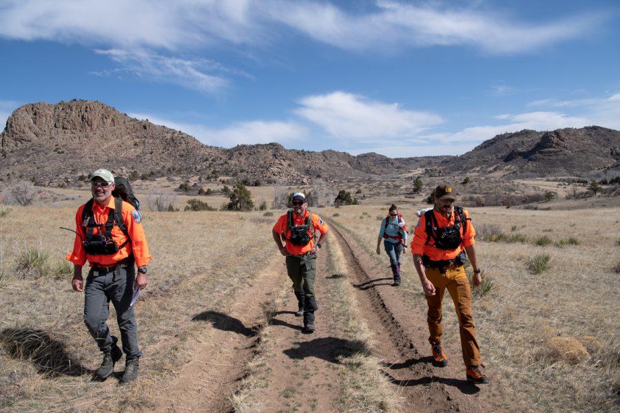 14. Tom Carney, Bob Townsend, Erica Exline and Ben Draper walk a road on the edge of their mock search area April 9.