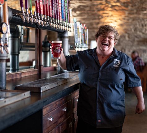 Jennifer Seiwald, owner of Scrump's in Old Town, Fort Collins holds a pint of in house made cider