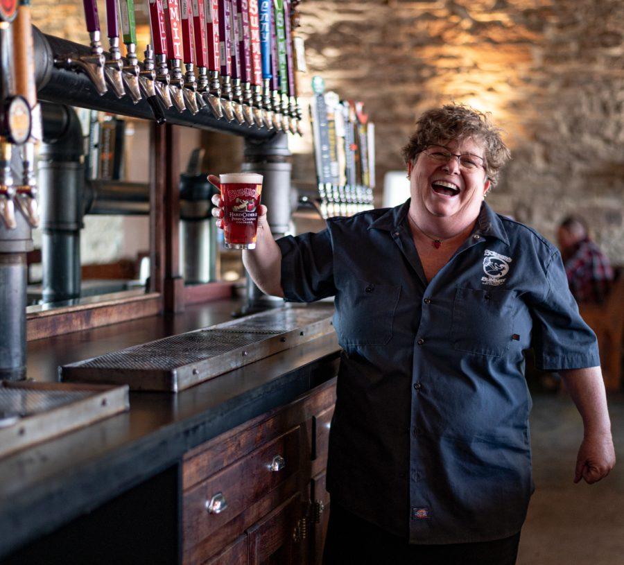 Jennifer Seiwald, owner of Scrumps in Old Town, Fort Collins holds a pint of in house made cider