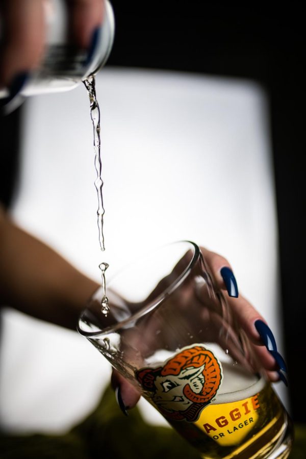 A can of New Belgium Brewing's Old Aggie lager is poured into a pint glass